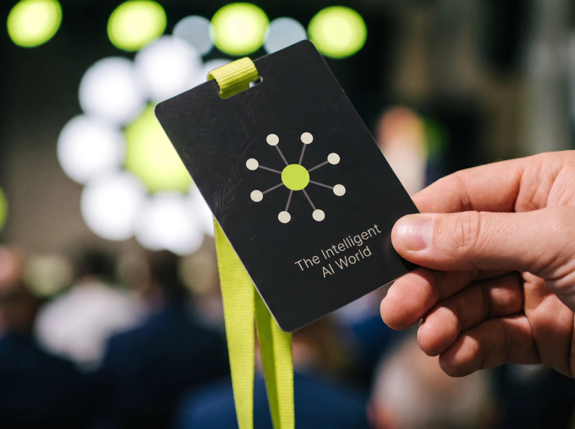 An IAW event badge held in hand